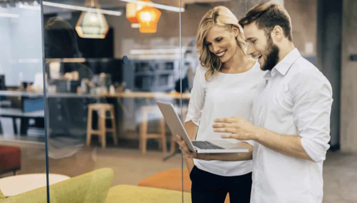 Friendly professionals collaborating in a modern office environment, focusing on IT training and career growth opportunities at MyComputerCareer.