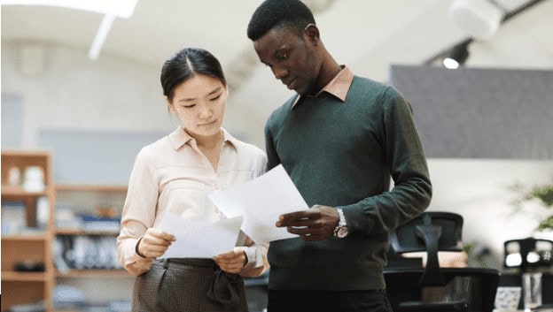 Diversity of students engaging with educational materials in a modern classroom setting.