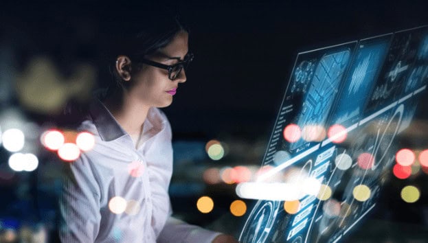 Female IT professional working with advanced digital interfaces at night, cybersecurity, tech careers, computer science education.