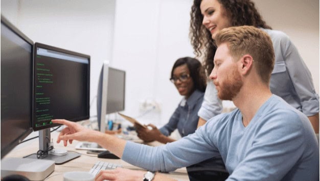 Students collaborating on coding projects in a computer lab at MyComputerCareer for IT training and career development opportunities.