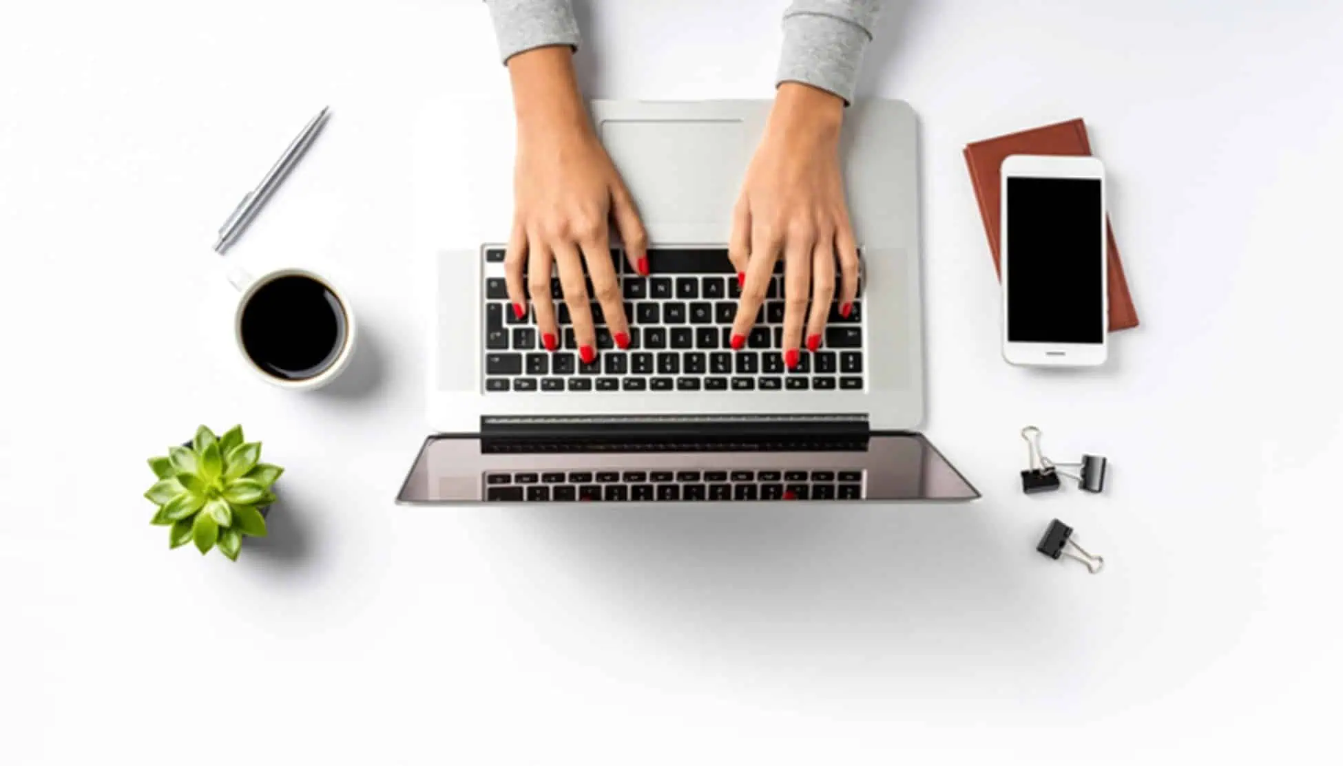 Laptops and workspace with woman typing, top view for online IT training at MyComputerCareer, learning computer and technology skills for career advancement.