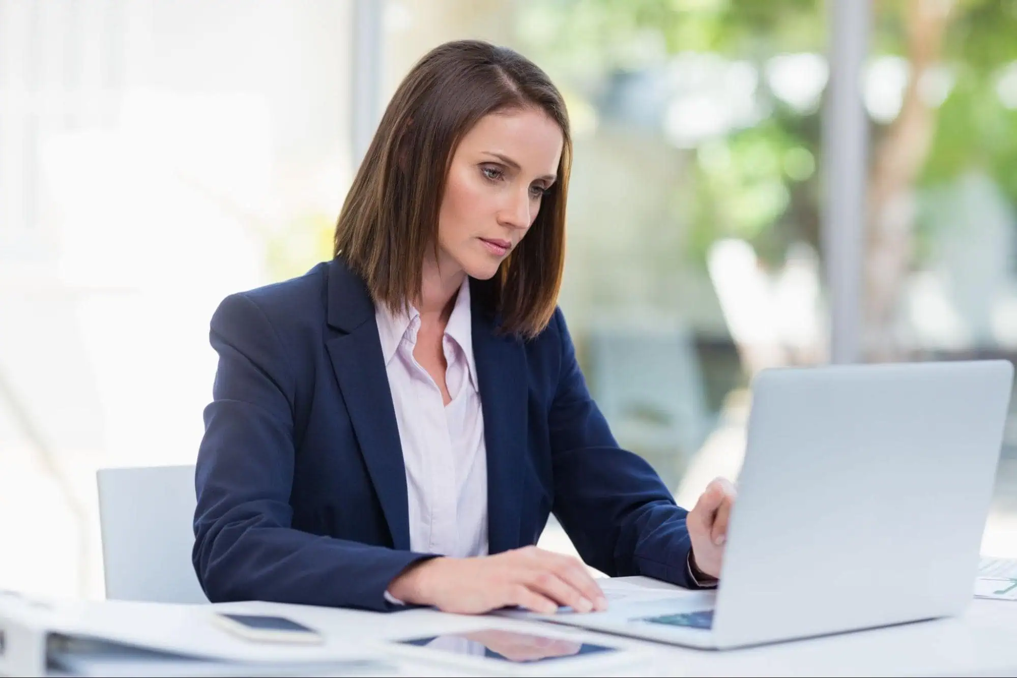 Professional woman studying computer networking at a modern tech school, focusing on IT training and career growth with MyComputerCareer.