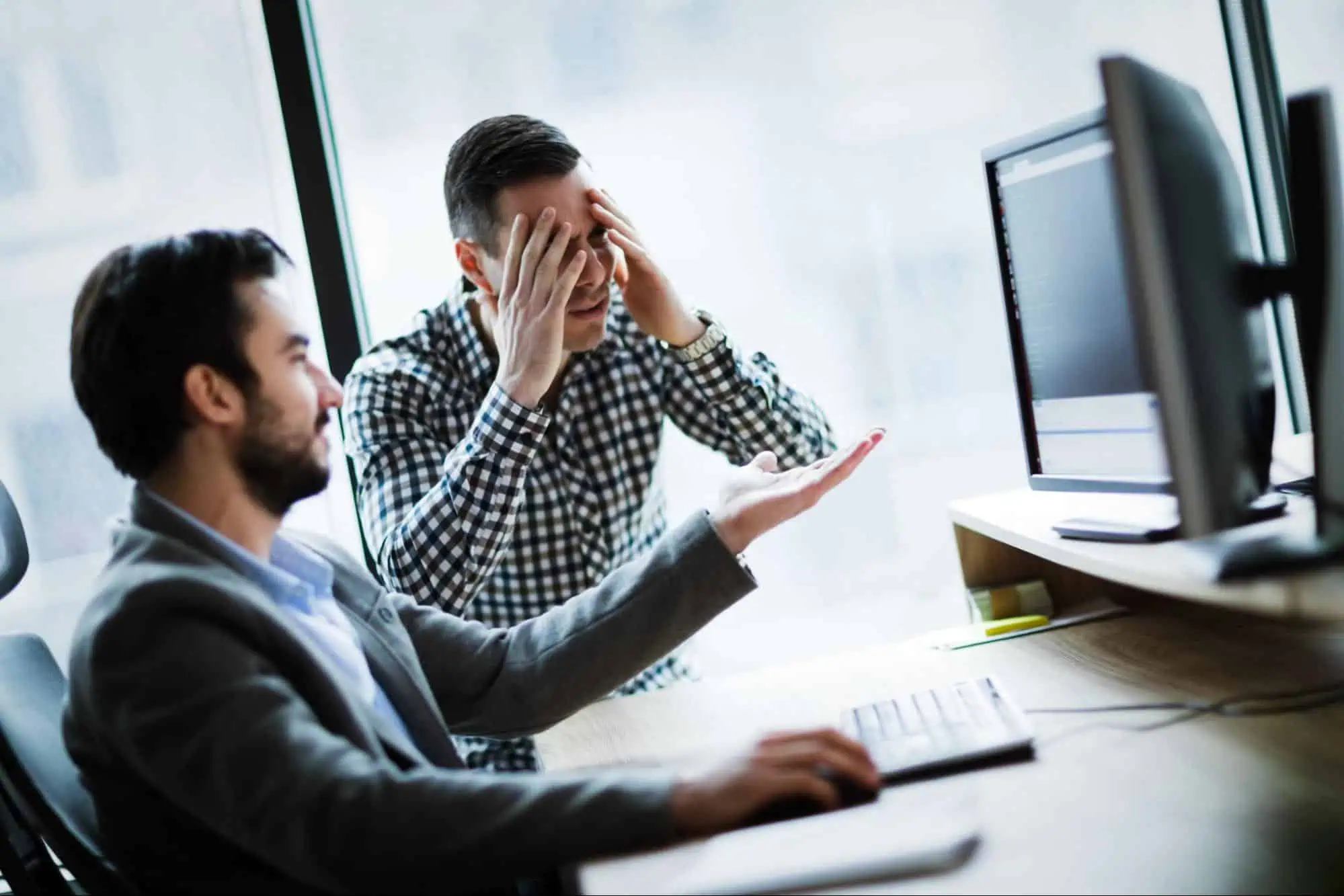 Frustrated man experiencing computer issues during a tech training session at MyComputerCareer.
