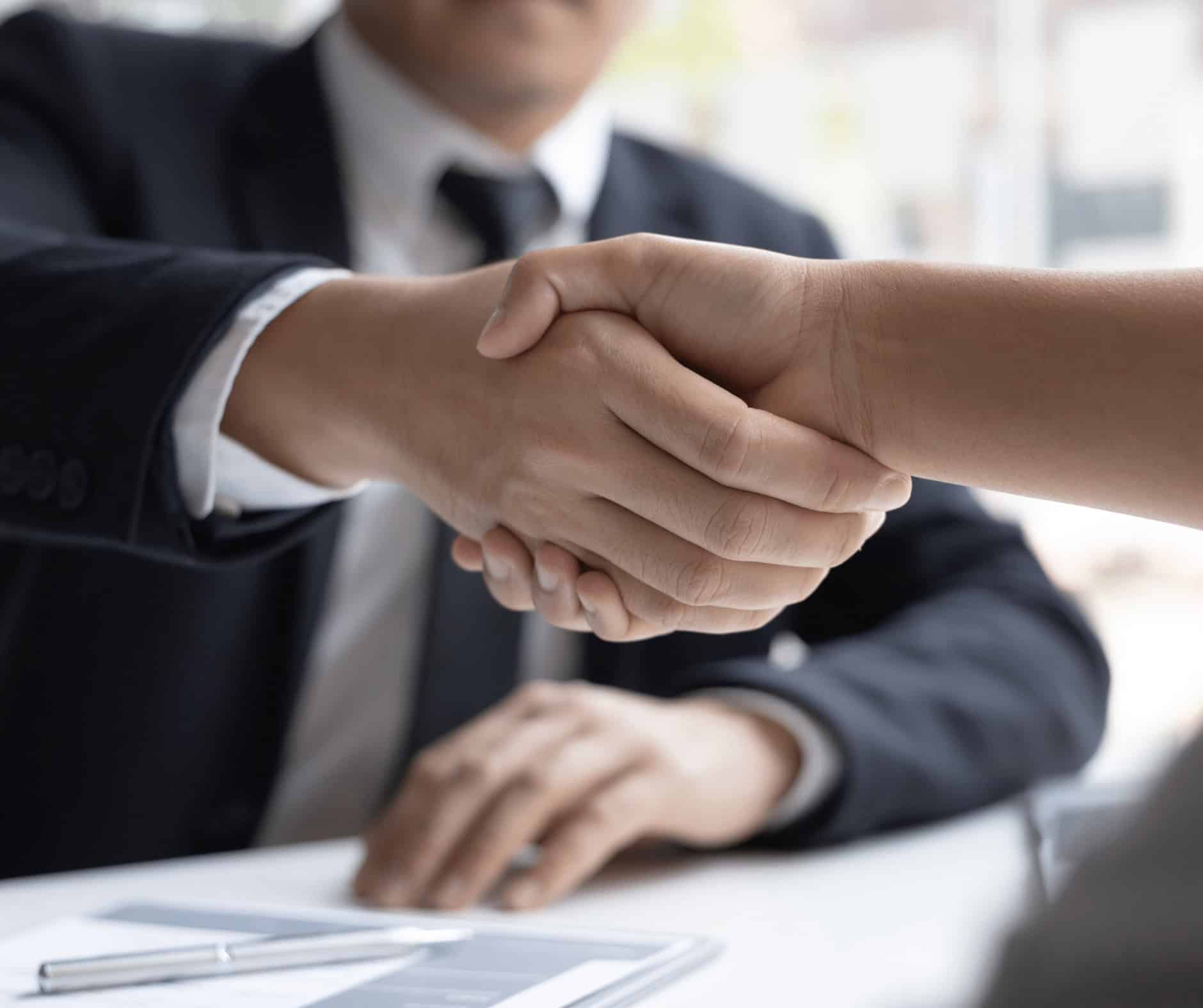 Handshake between a man in a business suit and a woman, symbolizing career opportunities and professional connections at MyComputerCareer.