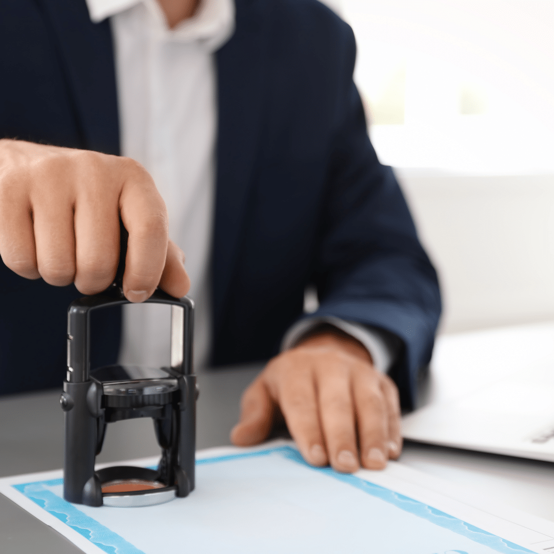 Professional man stamping documents at desk in modern office to represent career opportunities in IT and tech education from MyComputerCareer.