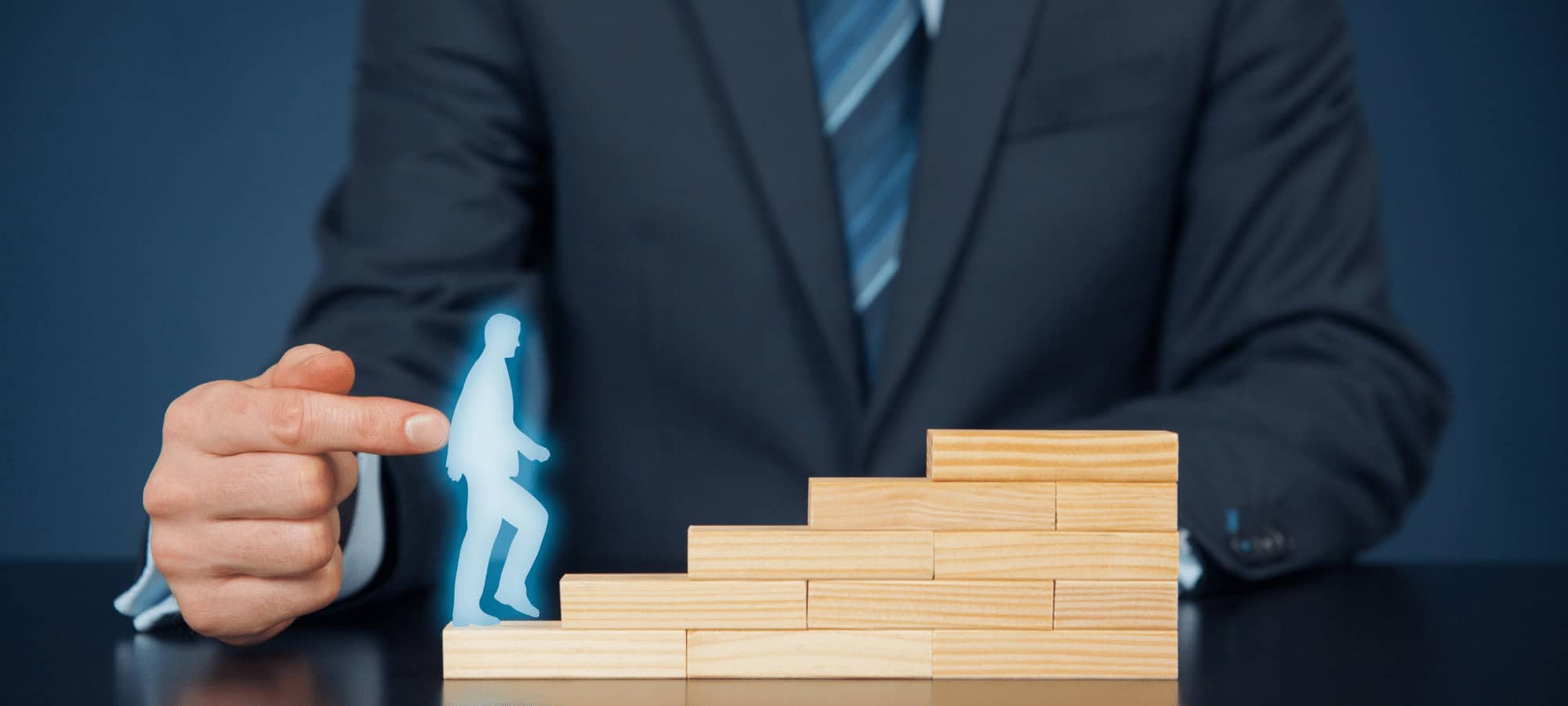 Success-driven professional in a business suit interacts with a digital walking figure on top of wooden blocks, symbolizing career growth and technology education at MyComputerCareer.