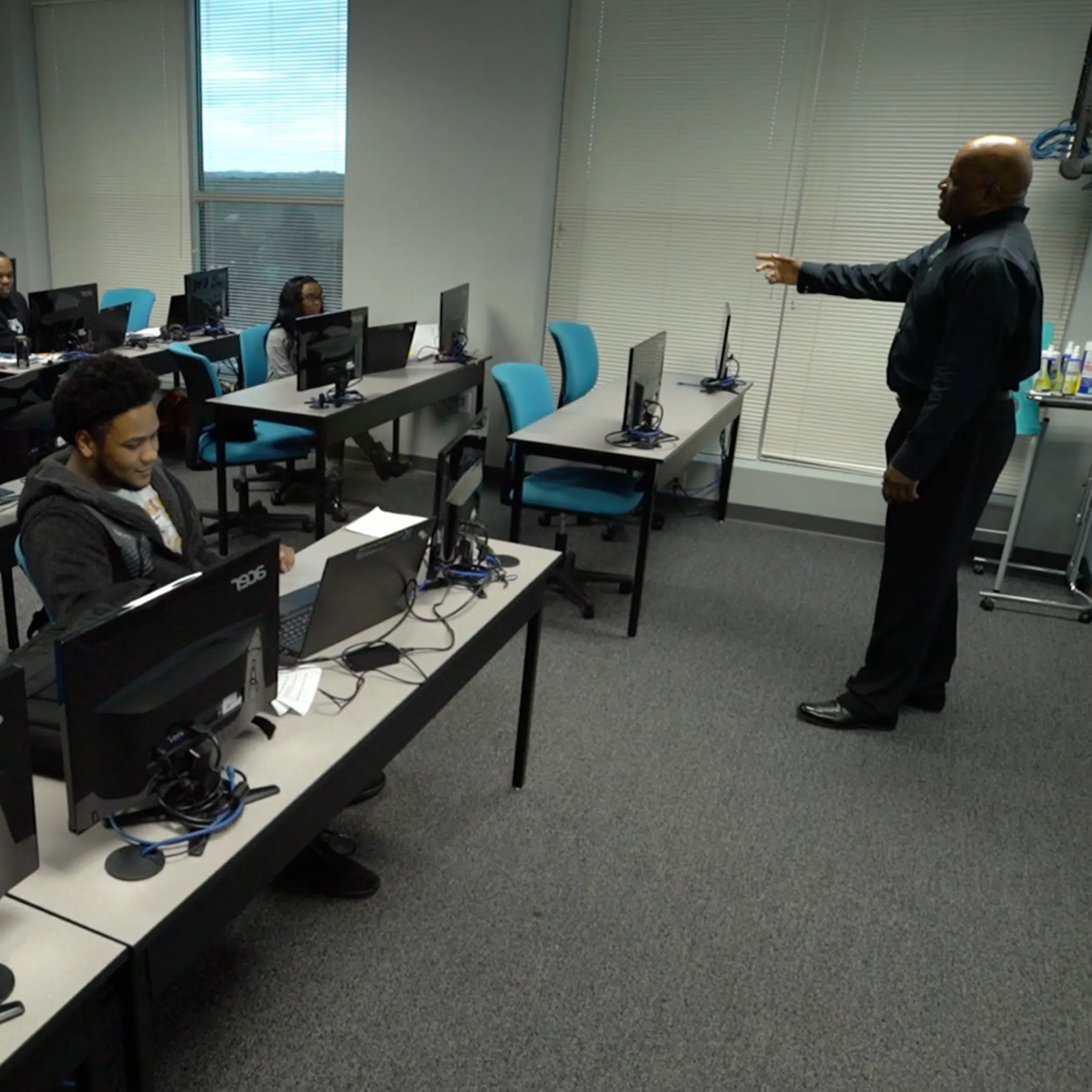 Professional computer training classroom with students learning IT skills.