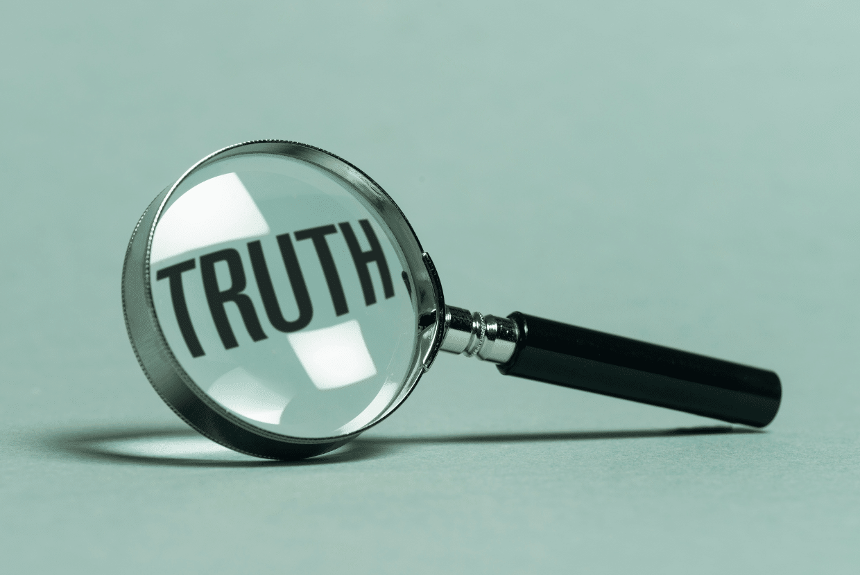 Truth magnifying glass focusing on honesty and transparency in computer career training programs.