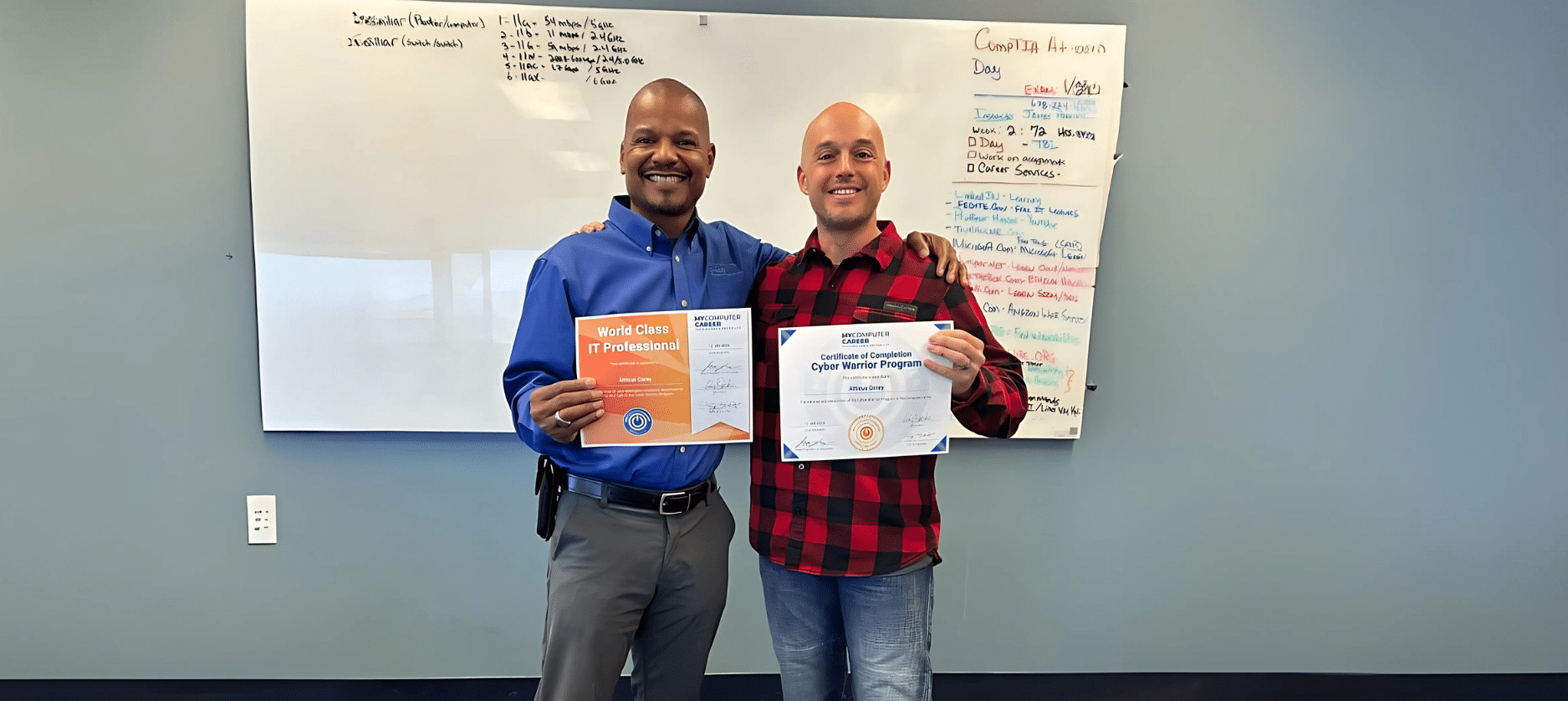 Veteran Atticus Corey and instructor celebrating IT career success with a certificate