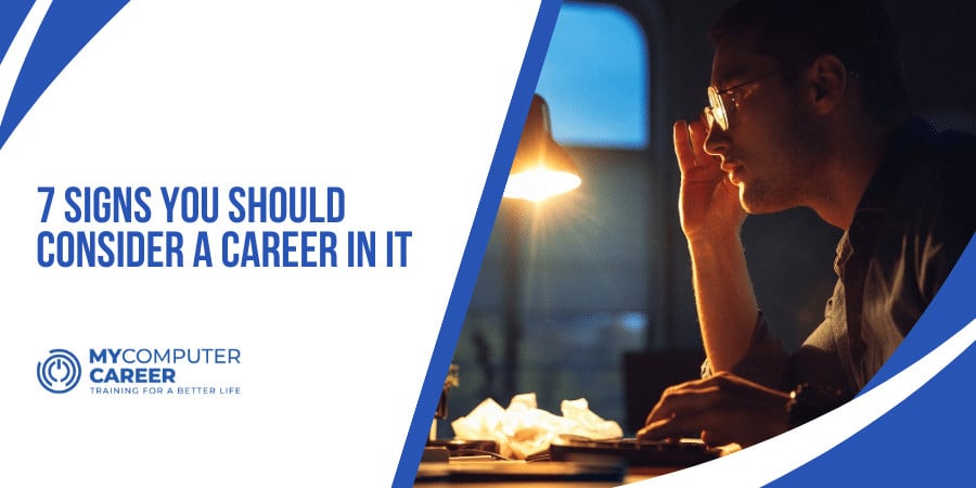 Person in a dimly lit room working on a laptop, a sign of a potential IT career