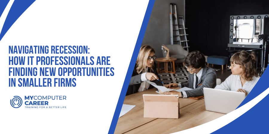 Three IT professionals collaborating at a computer, navigating recession by finding new opportunities at a smaller firm.