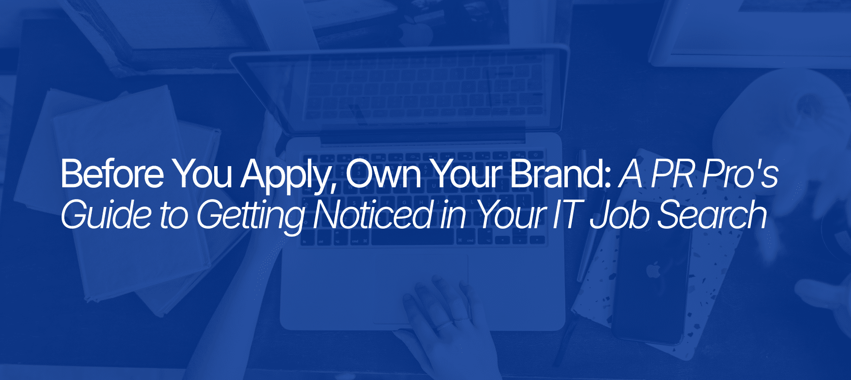 Laptop workspace with IT job search branding text