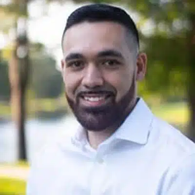 Smiling man in white shirt outdoors
