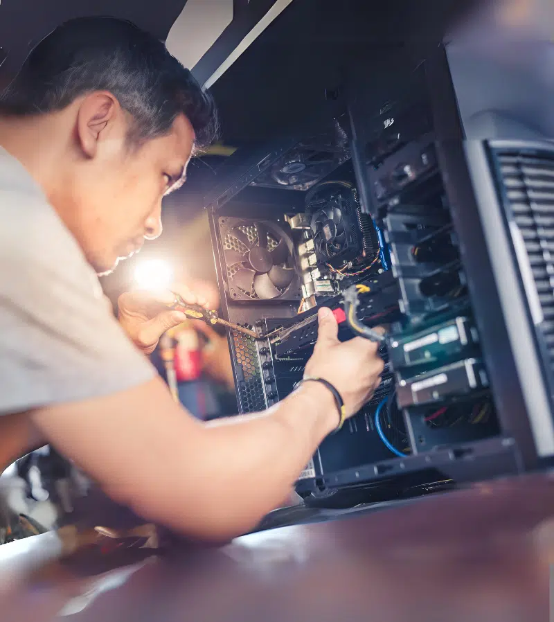 Man repairing desktop computer with screwdriver