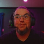 Man wearing headset and glasses in neon lighting