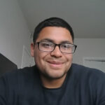 Smiling man with glasses indoors