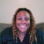 Smiling woman with long curly highlighted hair