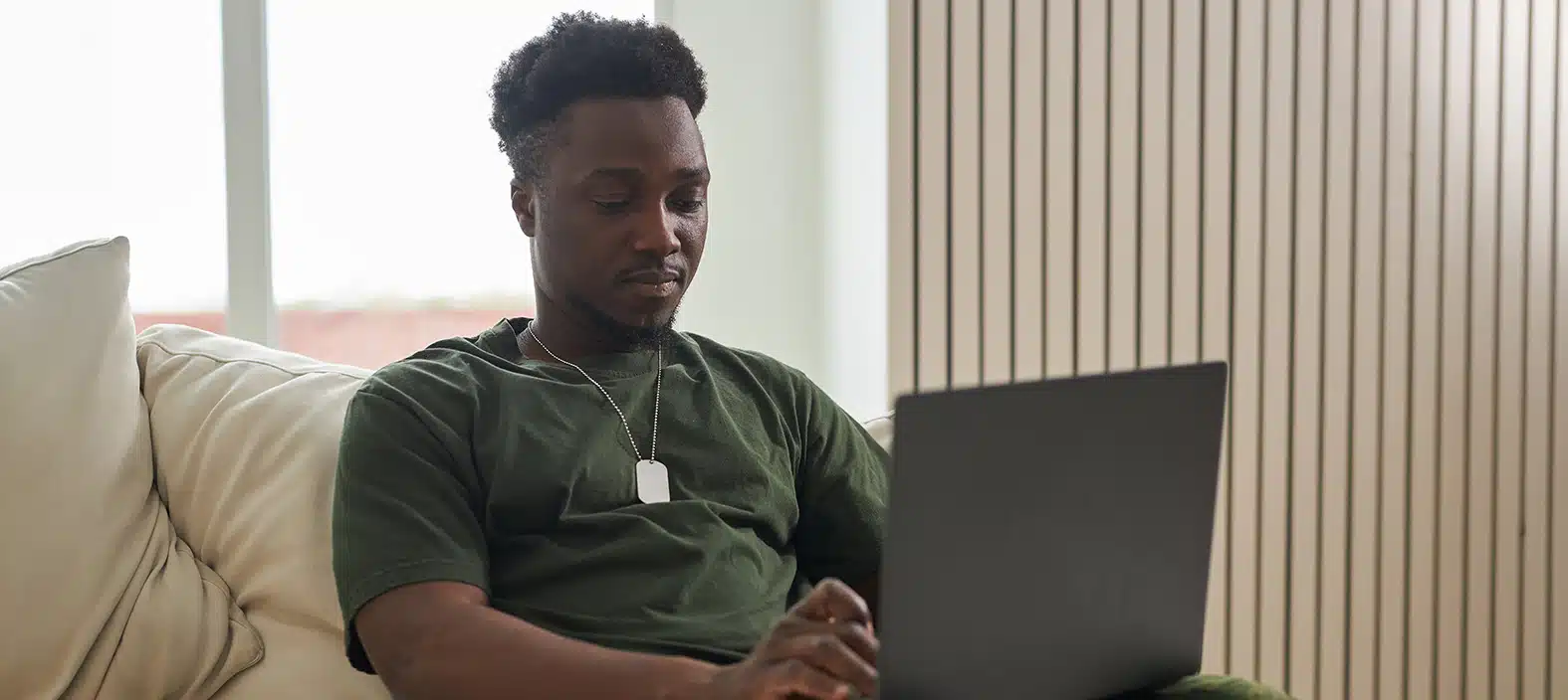 Man using laptop while seated on a couch