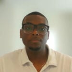 Man wearing glasses and white collared shirt