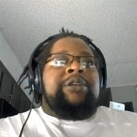 Man wearing glasses and headphones indoors