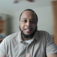 Man speaking to camera indoors