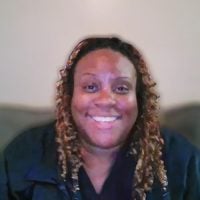 Smiling woman with long curly highlighted hair