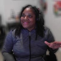 Person smiling wearing headset indoors