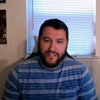 Bearded man in striped shirt indoors