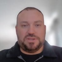 Man with shaved head and beard indoors