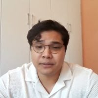 Man wearing glasses and white shirt indoors