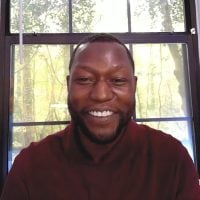 Smiling man in front of sunlit window