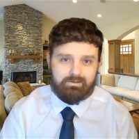 Bearded man in tie in cozy living room
